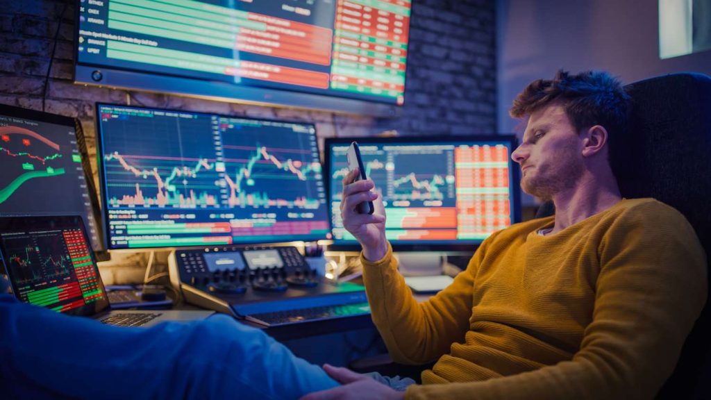 Trader analyzing market trends using FXCM AI tools on a computer screen.